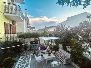 a balcony with a table and chairs and flowers at Alexandra's House in Skiathos