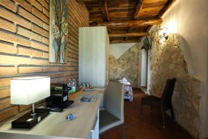 an office with a desk with a computer on it at VILLA MARIA ELENA Charme Rooms sul mare in Capo Vaticano