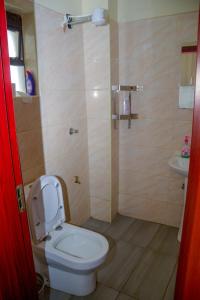 a bathroom with a toilet and a sink at BA STADEVIEW WEST STUDIOs in Nairobi +18 photos