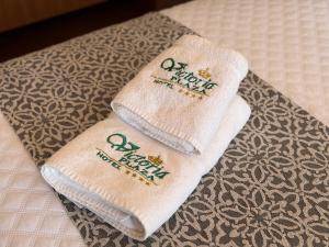 two towels with the words happy new year on them at Hotel Victoria Plaza in Tarija