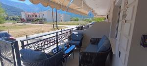 a balcony with chairs and a view of a street at Th Tsimas Luxury studio 4 in Skala Potamias