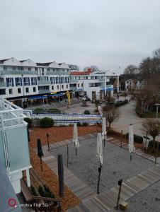 a group of white umbrellas in front of a building at Am Zingster Strand in Zingst