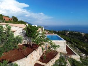 an external view of a villa with a swimming pool at Villa ACROPOLIS in Jal