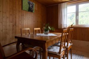 a dining room with a wooden table and chairs at Berghaus Antonia in Mellau