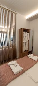 a bed with two white towels on top of it at Th Tsimas Luxury studio 4 in Skala Potamias