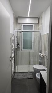 a bathroom with a toilet and a glass shower at Forte2110 in Misano Adriatico +18 photos