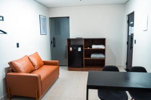 a living room with a couch and a table at You Smart Flats - Hotel in Formosa