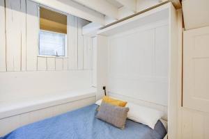 a small room with a bed and a window at Cozy Bungalow 7 Blocks from ND Campus in South Bend