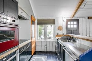 a kitchen with stainless steel appliances and a window at Cozy Bungalow 7 Blocks from ND Campus in South Bend