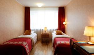 Postel nebo postele na pokoji v ubytování Fosshotel Rauðará