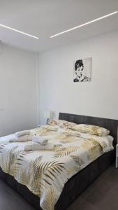 a bedroom with a bed with a black and white comforter at Forte2110 in Misano Adriatico