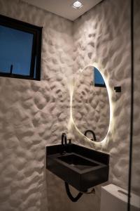 a bathroom with a black sink and a mirror at You Smart Flats - Hotel in Formosa