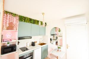 a small kitchen with a sink and a microwave at Studio les 2 fées - Jacuzzi - Forêt de Brocéliande in Montfort-sur-Meu