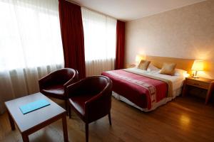 Postel nebo postele na pokoji v ubytování Fosshotel Rauðará