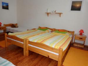 A bed or beds in a room at Penzión Gardoš