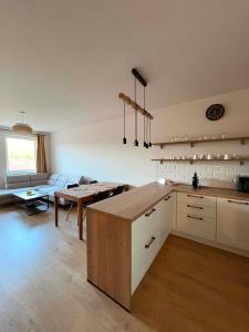 a kitchen with a table and a couch in a room at Apartmán JAMI REZIDENCIA in Spišské Podhradie