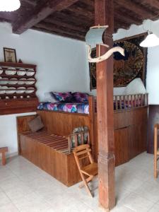 a bedroom with a bunk bed and a wooden pole at sevas'view in Émbonas