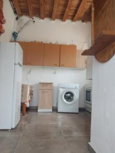 a kitchen with a washing machine and a refrigerator at sevas'view in Émbonas +29 photos