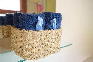 a basket filled with blue and purple towels on a table at sevas'view in Émbonas