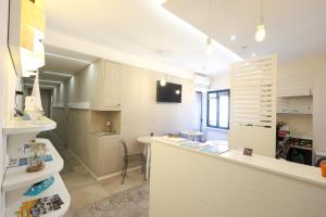 a kitchen with white cabinets and a counter top at Chez Moi Tropea Centro in Tropea +29 photos