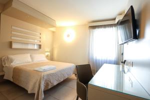 a small bedroom with a bed and a window at Chez Moi Tropea Centro in Tropea