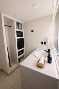 a white bathroom with a bath tub with a sink at HOTEL LOS ROBLES in Nuevo Laredo +211 photos