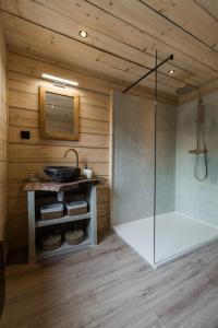 a bathroom with a shower in a wooden wall at Wood Chalet Durbuy in Durbuy +22 photos