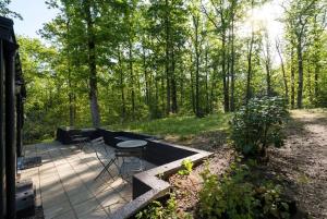 a patio with a table and chairs on it at Wood Chalet Durbuy in Durbuy