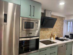 a kitchen with a stainless steel stove and refrigerator at El Olivo Verde 2 in Jaén
