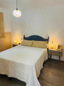a bedroom with a large white bed in a room at El Olivo Verde 2 in Jaén