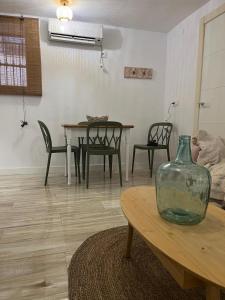 a living room with a vase on a table at El Olivo Verde 2 in Jaén