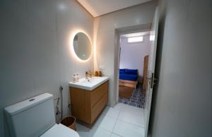 a bathroom with a toilet and a sink and a mirror at Dar Mounia Les Oudayas in Rabat