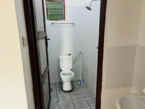a small bathroom with a toilet and a sink at Studio in kilifi close to beach and supermarket in Kilifi