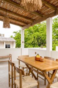 a wooden table and chairs on a patio at Bahía Sirenas in Puerto Escondido