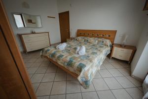 a bedroom with a bed with two towels on it at Orli Home e Relax in Casole dʼElsa