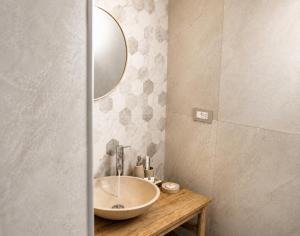 a bathroom with a sink and a mirror at LIGEA APARTMENT - Bright Mediterranean Home with Bali-Inspired Touches - Central Anzio near Sea, Train and Bus Station in Anzio +15 photos