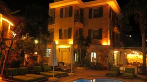 a building with a pool in front of a house at Villa Grande Kalkan in Kaş