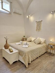 a bedroom with a large bed in a room at La Loggia, Historic Center in Grottaglie