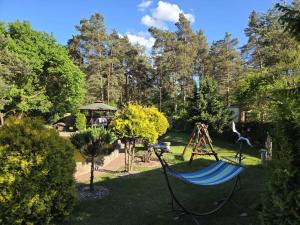 a hammock in the middle of a garden at Nestor Baron in Borkowo