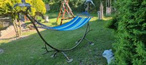 a hammock in a yard with a sheep in the grass at Nestor Baron in Borkowo +14 photos