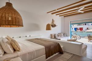 a bedroom with a bed and a view of the ocean at Beach Suite Syrma in Pachaina