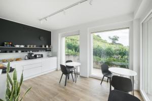 a kitchen with two tables and chairs and a window at el Zhìgol B&B in Farra di Soligo