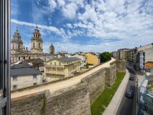 a view of the city from a wall at Hostal Porta Santiago in Lugo +36 photos