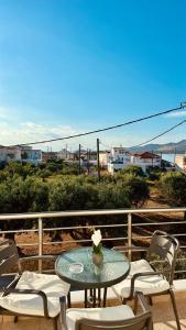 a table and chairs on a balcony with a view at Niko's apartments 2 in Elafonisos