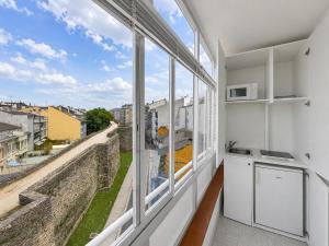 a kitchen with a large window overlooking a city at Hostal Porta Santiago in Lugo