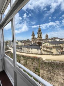 a view of a city from a window at Hostal Porta Santiago in Lugo