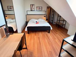 a bedroom with a bed and a staircase with a mirror at ibis Hotel Nürnberg Altstadt in Nuremberg +64 photos