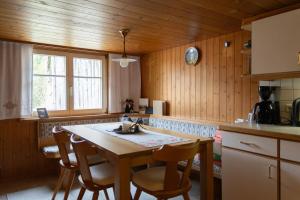 a kitchen with a table and chairs in a room at Berghaus Antonia in Mellau +8 photos
