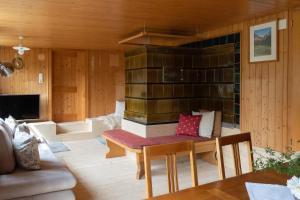 a living room with a table and a fireplace at Berghaus Antonia in Mellau