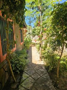 a path outside of a house with trees and a building at Mnchunge's Residence in Kikambala